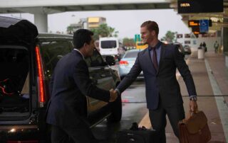 Image of a chauffeur receiving a passenger at airport arrivals
